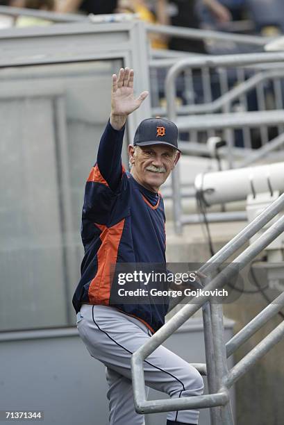 Manager Jim Leyland of the Detroit Tigers smiles while waving to fans from the dugout before the start of a game against the Pittsburgh Pirates at...