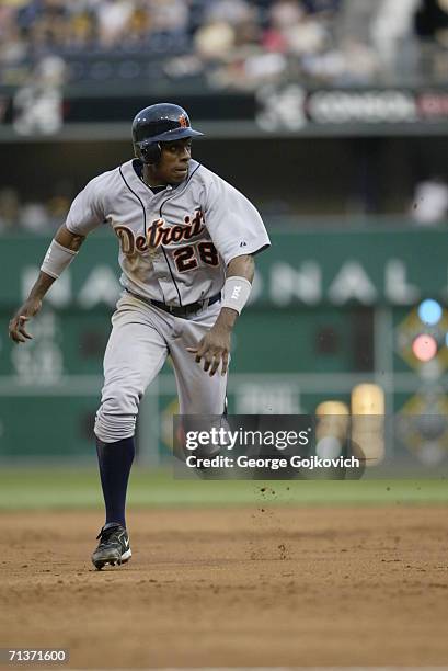 Outfielder Curtis Granderson of the Detroit Tigers runs between second and third base during a game against the Pittsburgh Pirates at PNC Park on...