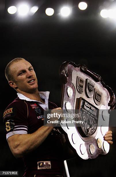 Darren Lockyer of Queensland celebrates victory with the Harvey Norman Shield in the match between the New South Wales Blues and Queensland Maroons...