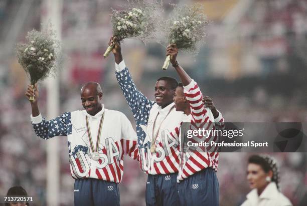 American track and field athletes, from left, silver medallist Mike Powell, gold medallist Carl Lewis and bronze medallist Joe Greene of the United...