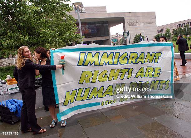 Protesters hold a sign outside a Senate Hearing on Illegal Immigration at the National Constitution Center July 5, 2006 in Philadelphia,...