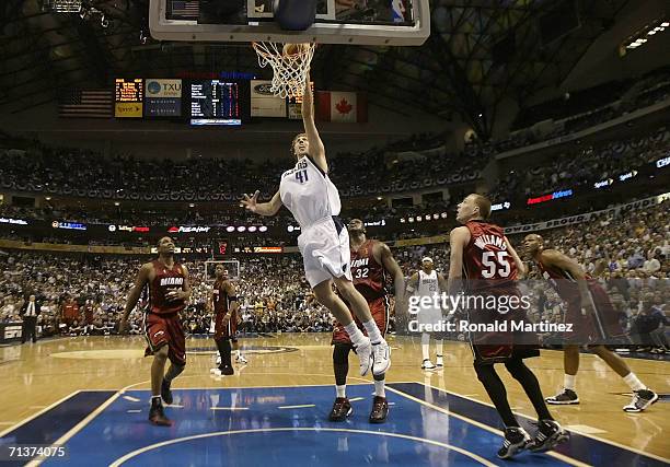 Dirk Nowitzki of the Dallas Mavericks lays a shot up over Udonis Haslem, Jason Williams and Shaquille O'Neal of the Miami Heat in the second quarter...