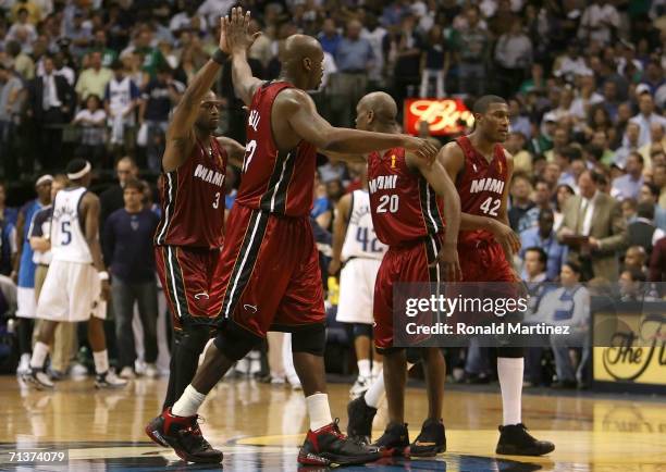 Dwyane Wade, Shaquille O'Neal, Gary Payton and James Posey of the Miami Heat celebrate together during a timeout against the Dallas Mavericks in game...