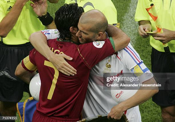 Opposing captains, Luis Figo of Portugal and Zinedine Zidane of France hug each other prior to kickoff during the FIFA World Cup Germany 2006...