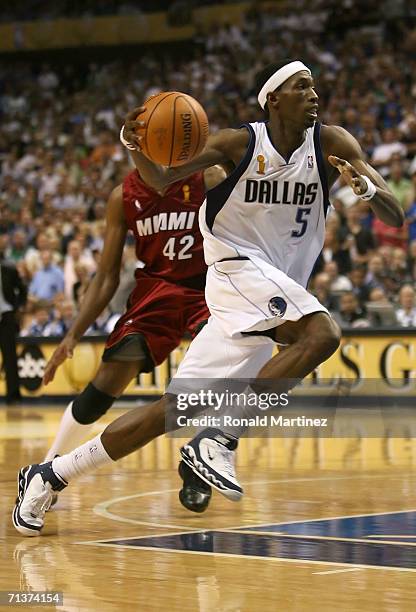Josh Howard of the Dallas Mavericks moves past James Posey of the Miami Heat in game six of the 2006 NBA Finals on June 20, 2006 at American Airlines...