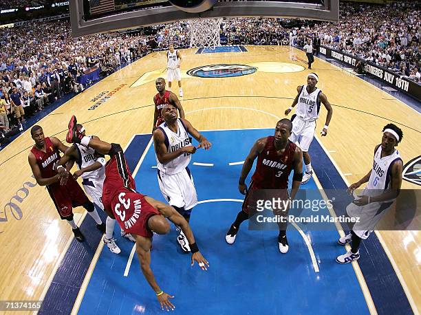 Alonzo Mourning of the Miami Heat falls under the basket over Jason Terry of the Dallas Mavericks in game six of the 2006 NBA Finals on June 20, 2006...