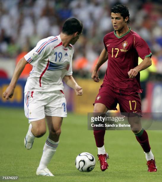 Cristiano Ronaldo of Portugal is challenged by Willy Sagnol of France during the FIFA World Cup Germany 2006 Semi-final match between Portugal and...