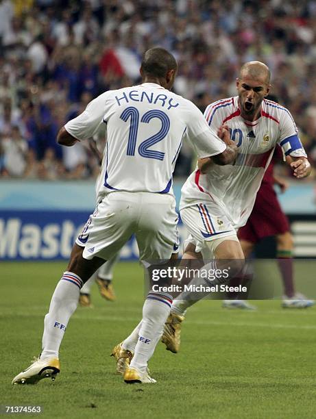 Zinedine Zidane of France turns away to celebrate with teammate Thierry Henry , after scoring the opening goal from the penalty spot during the FIFA...