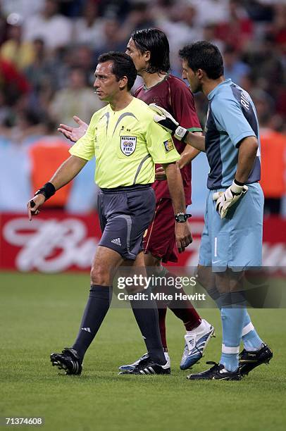 Goalkeeper Ricardo of Portugal speaks with Referee Jorge Larrionda of Uruguay, after a penalty is awarded against his team during the FIFA World Cup...