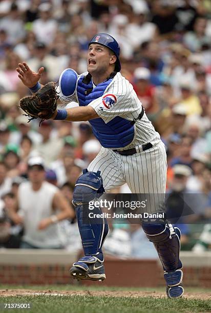 Catcher Michael Barrett of the Chicago Cubs moves to catch the pop fly during the game against the Chicago White Sox on July 1, 2006 at Wrigley Field...