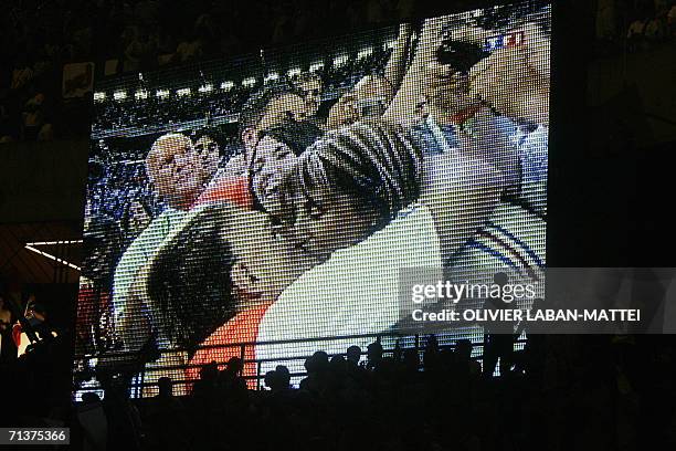 French football fans support their team at the Parc des Princes stadium in Paris as they watch the game on a giant screen showing the French football...