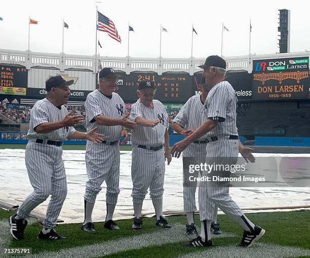 Former catcher and manager Yogi Berra prepares to jump into the arms of former pitcher Don Larsen during Old Timers Day on June 24, 2006 at Yankee...