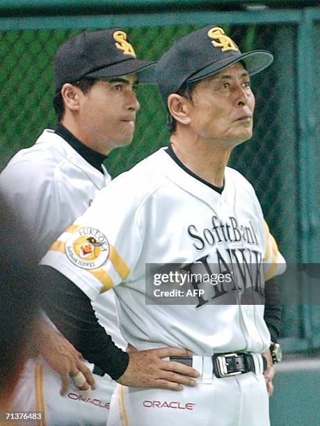 Japan's professional baseball team Softbank Hawks manager Sadaharu Oh and head coach Hiroshi Moriwaki watch the game between Hawks and Seibu Lions at...