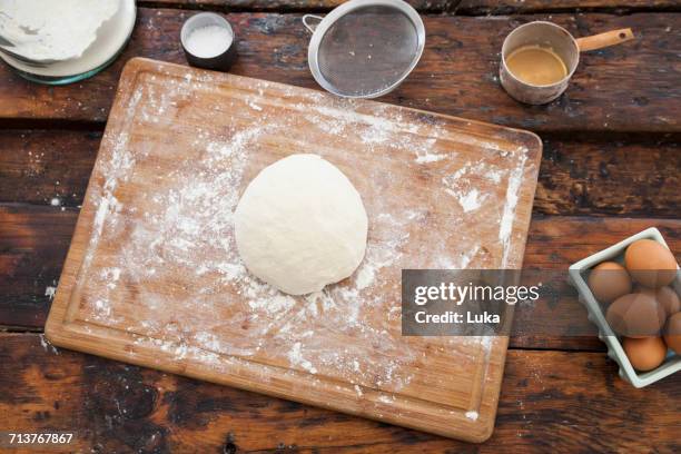 overhead view of dough on floured cutting board - chopping block flour stock pictures, royalty-free photos & images