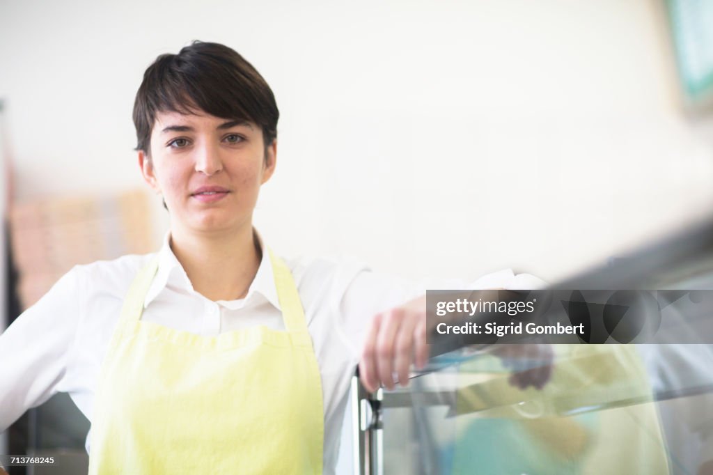 Portrait of young woman, working in fast food shop