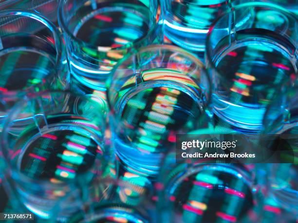 genetic research, a human sample in a multi well plate ready for genetic analysis with a dna sequence in the background - medical sample - fotografias e filmes do acervo