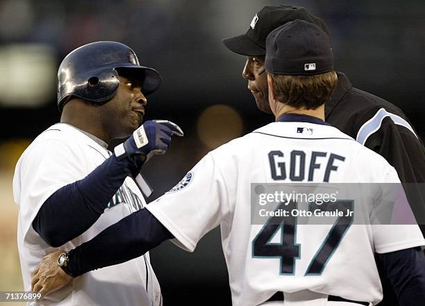 Carl Everett of the Seattle Mariners argues with second base umpire Chuck Meriwether during the game against the Los Angeles Angels of Anaheim on...