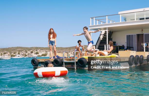 family having fun on houseboat sun deck, kraalbaai, south africa - hausboot stock-fotos und bilder