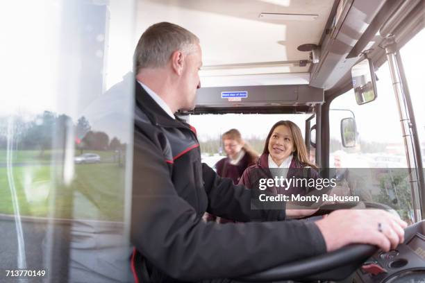 bus driver with passengers boarding electric bus - bus driver stock pictures, royalty-free photos & images
