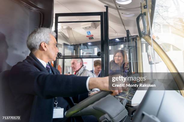 bus driver with passengers boarding electric bus - バス運転手 ストックフォトと画像