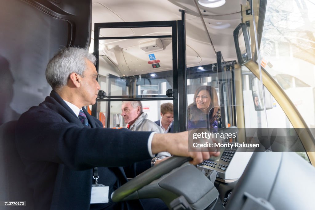 Bus Driver With Client Bus Driver With Passengers Boarding Electric Bus High-Res Stock Photo ...