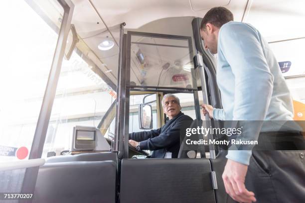 bus driver with passengers boarding electric bus - バス運転手 ストックフォトと画像