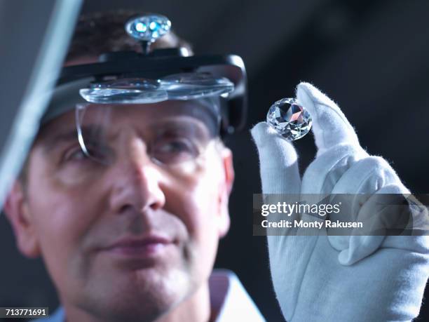 jeweller inspecting replica diamonds - diamond jeweller stock pictures, royalty-free photos & images