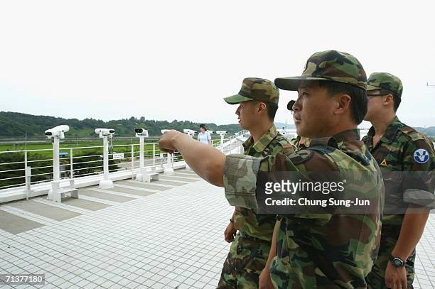 South Korean soldier looks across the border to the North near the demilitarized zone separating North and South Korea on July 6, 2006 in Paju, South...