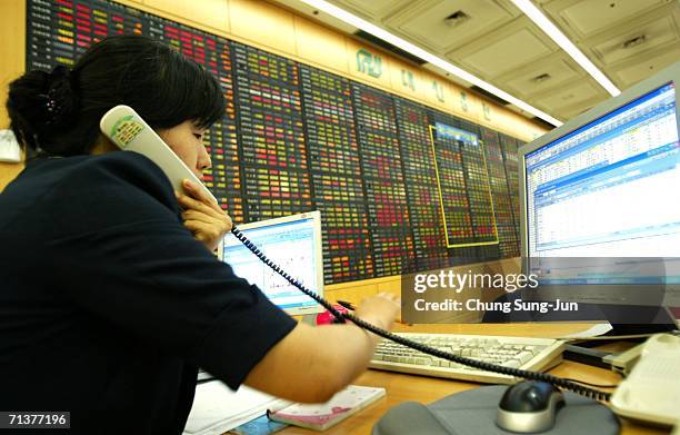 Stock market employee working after the KOSPI fell 1.57 percent to 1,259.78 on July 6, 2006 in Seoul, South Korea. Further falls are expected as...