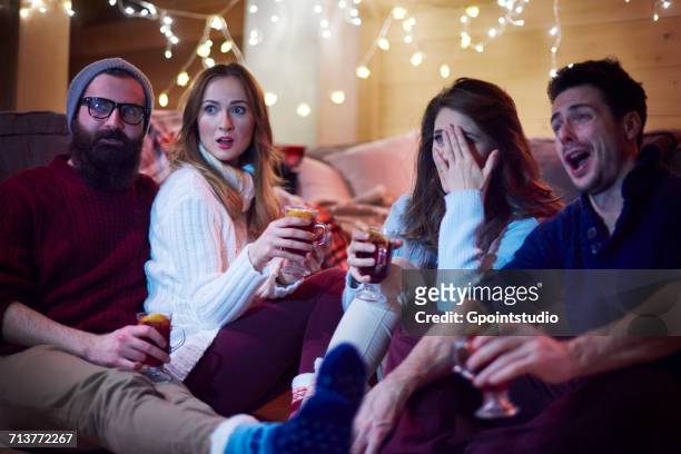 friends enjoying mulled wine in chalet - the house film 2017 stock-fotos und bilder