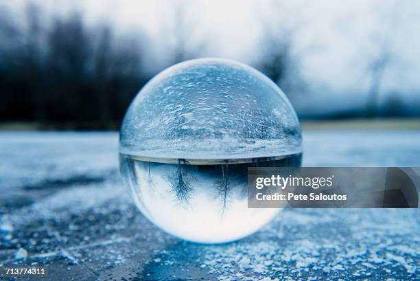 close up of crystal ball on frozen lake - bainbridge island 個照片及圖片檔