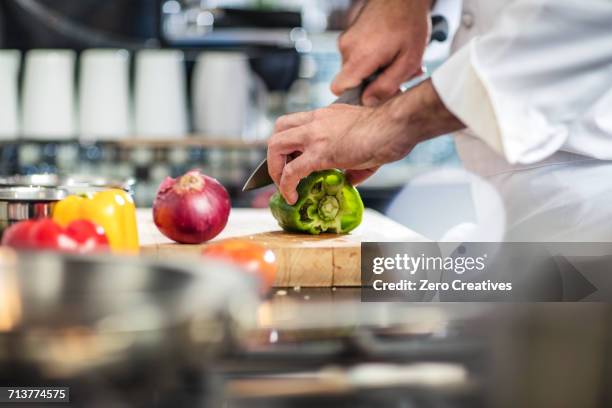 chef chopping green pepper on chopping board - cutting red onion stock pictures, royalty-free photos & images