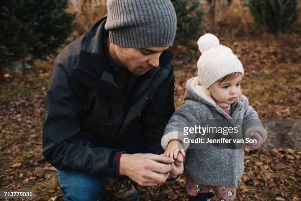 father holding hand of baby girl in forest - cobourg imagens e fotografias de stock