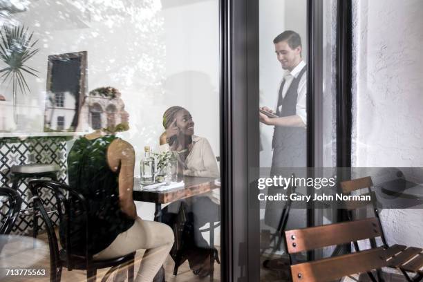 waiter serving diners in restaurant - palm beach dining stock pictures, royalty-free photos & images