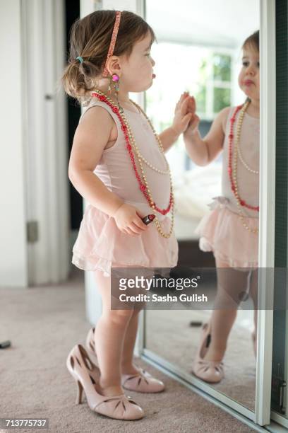 girl dressing up, playing with lipstick - tacones altos fotografías e imágenes de stock