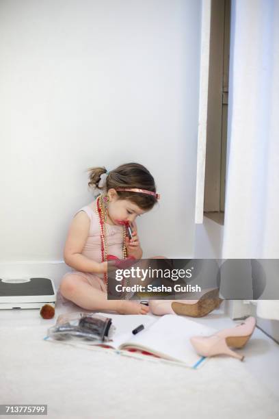 girl dressing up, playing with lipstick - stiletto girl stock pictures, royalty-free photos & images