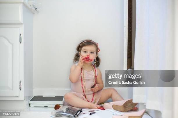 girl dressing up, playing with lipstick - baby gender reveal stock pictures, royalty-free photos & images