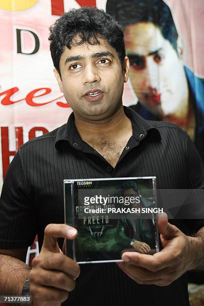 Pakistani singer Abrar-ul-Haq poses with a CD of his newly-released album 'Preeto', during a press conference in New Delhi 06 July 2006. The album...