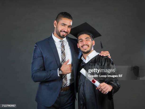 an arab dad and son on graduation|- - arab expat family stock pictures, royalty-free photos & images