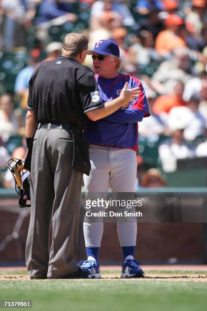 Manager Buck Showalter of the Texas Rangers talks with homeplate umpire Mike Everitt during the game against the San Francisco Giants at AT&T Park in...