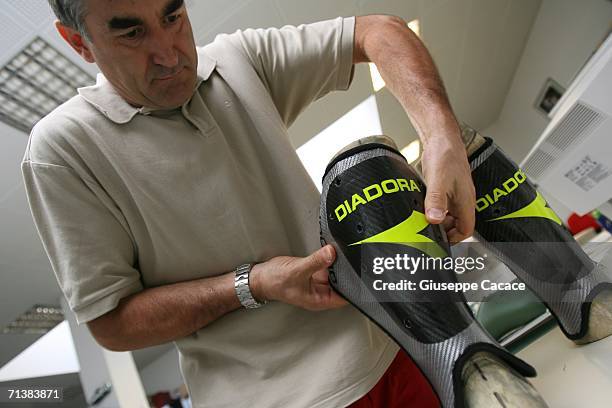 Angelo Mason, head of Diadora's Research and Development department, tests the carbon fibers of Francesco Totti's specially made shinguards to...