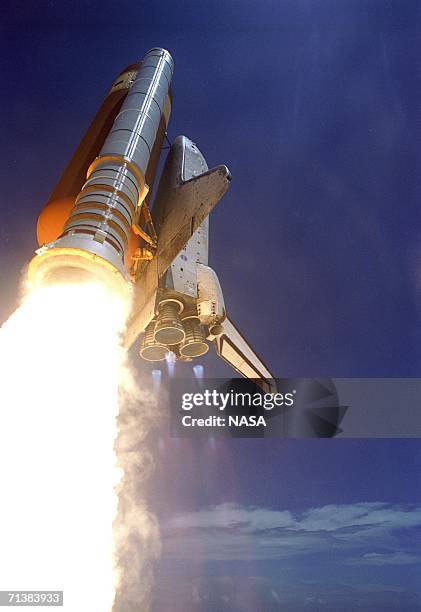 In this handout photo provided by NASA, Space Shuttle Discovery kicks off the Fourth of July fireworks with its own fiery display as it rockets into...