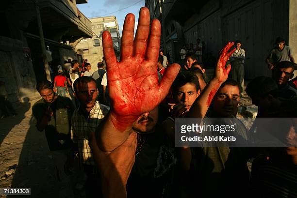 Palestinian face off with an Israeli tank during clashes July 6, 2006 in Beit Lahia, northern Gaza Strip. Israeli infantry and armor launched a...