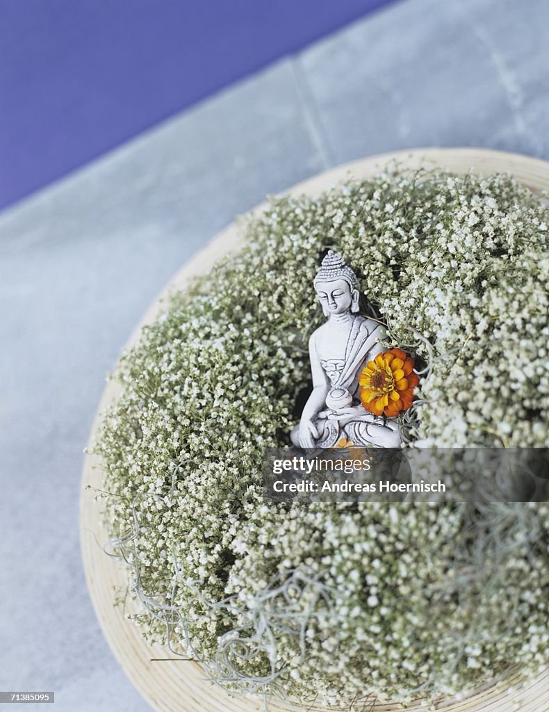 Buddha figurine embedded on baby\\\'s breath