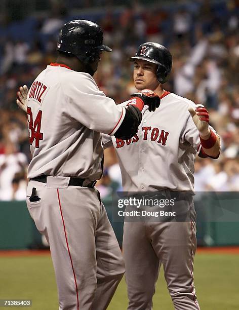 Mark Loretta of the Boston Red Sox congratulates teammate David Ortiz on his two-run home run in the 5th inning against the Tampa Bay Devil Rays at...