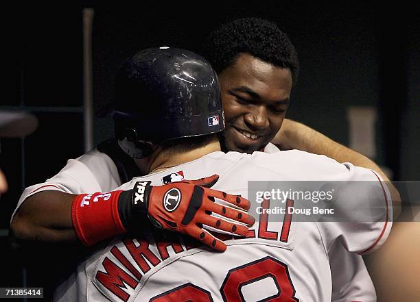 David Ortiz of the Boston Red Sox congratulates teammate Doug Mirabelli on his solo home run in the 5th inning against the Tampa Bay Devil Rays at...