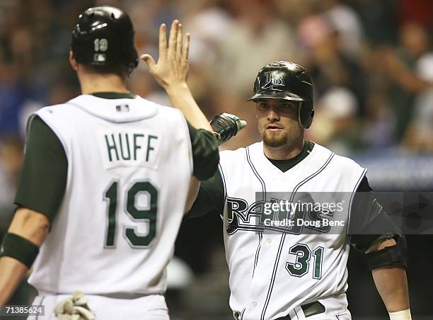 Jonny Gomes of the Tampa Bay Devil Rays congratulates teammate Aubrey Huff on scoring a run in the 6th inning against the Boston Red Sox at Tropicana...