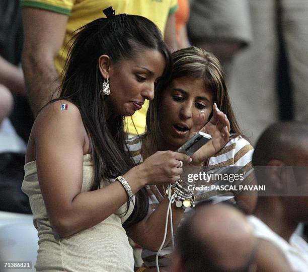 The wife of French defender Eric Abidal is seen with Wahiba Ribery , the wife of French forward Franck Ribery during the semi-final 2006 World Cup...