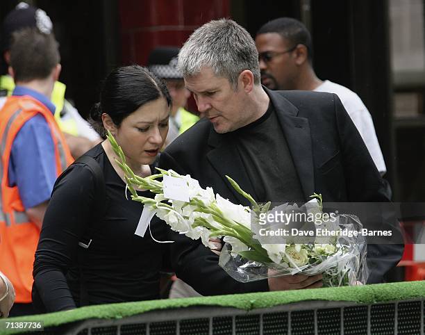 Mourners lay flowers at a ceremony to remember the victims of 7/7 bombings at Russell Square underground station on July 7, 2006 in London, England....