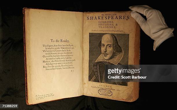 Sotheby?s employee handles a copy of William Shakespeare, The First Folio 1623 on July 7, 2006 in London, England. The most important book in English...
